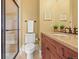 Bathroom featuring a glass shower door, granite counters, and neutral tile flooring at 1222 Buffalo Ridge Rd, Castle Pines, CO 80108