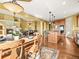 Open concept with a dining area with a fireplace, seating, and a modern kitchen at 1222 Buffalo Ridge Rd, Castle Pines, CO 80108