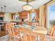 Formal dining room showcasing hardwood table with six chairs and natural lighting from the windows at 1222 Buffalo Ridge Rd, Castle Pines, CO 80108