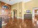 Spacious foyer with hardwood floors, arched doorway, and decorative wood door at 1222 Buffalo Ridge Rd, Castle Pines, CO 80108