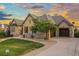Charming home featuring stone accents, a well-manicured lawn, and a two-car garage at 1222 Buffalo Ridge Rd, Castle Pines, CO 80108