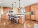 Spacious kitchen with hardwood floors, a center island, and stainless steel appliances at 1222 Buffalo Ridge Rd, Castle Pines, CO 80108