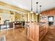 Spacious kitchen featuring an island with bar seating open to a living room with a fireplace at 1222 Buffalo Ridge Rd, Castle Pines, CO 80108