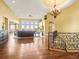 Bright living room with hardwood floors, large windows, and an elegant chandelier at 1222 Buffalo Ridge Rd, Castle Pines, CO 80108