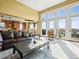 Bright living room with high ceilings, large windows, and an open floor plan at 1222 Buffalo Ridge Rd, Castle Pines, CO 80108