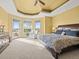 Main bedroom features a tray ceiling, sitting area and a private balcony at 1222 Buffalo Ridge Rd, Castle Pines, CO 80108