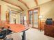 Home office features custom wood trim, a work desk, and a printer at 1222 Buffalo Ridge Rd, Castle Pines, CO 80108