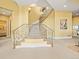 Elegant staircase with ornate wrought iron railing and carpeted steps at 1222 Buffalo Ridge Rd, Castle Pines, CO 80108