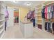Large walk-in closet with custom shelving and an island for organization at 1222 Buffalo Ridge Rd, Castle Pines, CO 80108