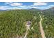 Mountain home nestled among the trees, with long driveway and surrounding forest, privacy guaranteed at 1758 Sinton Rd, Evergreen, CO 80439