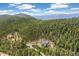 Majestic mountain home nestled in lush forest with stunning views of distant mountain ranges at 1758 Sinton Rd, Evergreen, CO 80439