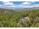 Gorgeous home nestled amidst trees with breathtaking views of rolling hills in the distance at 1758 Sinton Rd, Evergreen, CO 80439