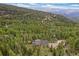 Expansive mountain views surrounding a home nestled in a dense, green forest; ultimate privacy at 1758 Sinton Rd, Evergreen, CO 80439