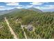 Scenic aerial view of a home surrounded by lush forests, highlighting its secluded mountain setting at 1758 Sinton Rd, Evergreen, CO 80439