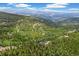 Mountain home surrounded by lush greenery, backing onto expansive views; peaceful and serene living at 1758 Sinton Rd, Evergreen, CO 80439
