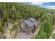 Secluded mountain home features expansive decks and lush forest surroundings for tranquil living at 1758 Sinton Rd, Evergreen, CO 80439