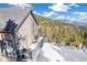 Back deck with outdoor seating, grill, and scenic mountain and tree views at 1758 Sinton Rd, Evergreen, CO 80439
