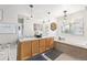 Bright bathroom featuring dual sinks, a soaking tub, and elegant lighting fixtures at 1758 Sinton Rd, Evergreen, CO 80439