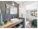 Modern bathroom with unique lighting, sleek mirror, and natural wood vanity near the bedroom at 1758 Sinton Rd, Evergreen, CO 80439
