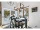 Dining area with modern lighting, mountain views from the windows and access to a deck at 1758 Sinton Rd, Evergreen, CO 80439