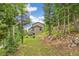 Secluded home's backyard featuring a hot tub and inviting seating area with forested surroundings at 1758 Sinton Rd, Evergreen, CO 80439