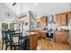 Open kitchen with wooden cabinets, stainless steel appliances, bar seating, and hardwood floors at 1758 Sinton Rd, Evergreen, CO 80439