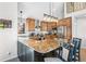 Kitchen with granite countertops, wooden cabinets, stainless steel appliances, and an island with barstool seating at 1758 Sinton Rd, Evergreen, CO 80439