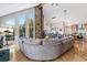 Open-concept living space with stone fireplace and floor to ceiling windows at 1758 Sinton Rd, Evergreen, CO 80439