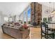 Bright living room with large windows, a stone fireplace, hardwood floors, and an open floor plan at 1758 Sinton Rd, Evergreen, CO 80439
