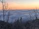 Scenic view with a beautiful sky over the clouds and treetops, offering a serene natural setting at 1758 Sinton Rd, Evergreen, CO 80439