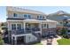 Two-story home with a covered patio, stone accents, a deck, and a brick patio for seamless indoor-outdoor living at 8605 S Zante Ct, Aurora, CO 80016