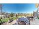 Expansive brick patio with multiple seating areas ideal for outdoor entertaining, complemented by a well-manicured lawn and fenced yard at 8605 S Zante Ct, Aurora, CO 80016