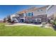 Charming backyard featuring a covered patio, stone detailing, a wood deck, and an inviting brick patio for outdoor enjoyment at 8605 S Zante Ct, Aurora, CO 80016