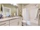 Clean bathroom with a white vanity, a large mirror, and a shower-tub combination at 8605 S Zante Ct, Aurora, CO 80016