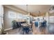 Bright dining area features wood floors, wainscoting, and an open concept connecting the kitchen to the dining area at 8605 S Zante Ct, Aurora, CO 80016