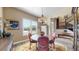 Inviting dining room boasts a round table, elegant decor, and a view of the entryway and staircase at 8605 S Zante Ct, Aurora, CO 80016