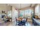 Charming dining area with a table set for four, plenty of natural light, and hardwood floors at 8605 S Zante Ct, Aurora, CO 80016