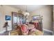 Formal dining room with a large wooden table, upholstered chairs, and a stylish chandelier at 8605 S Zante Ct, Aurora, CO 80016