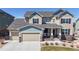 Beautiful two-story home with a three car garage and covered front porch at 8605 S Zante Ct, Aurora, CO 80016