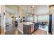Open kitchen featuring an island with seating, stainless steel appliances, and granite countertops at 8605 S Zante Ct, Aurora, CO 80016