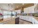 Modern kitchen featuring white cabinets, granite countertops, stainless steel appliances, and island seating at 8605 S Zante Ct, Aurora, CO 80016
