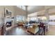 Open-concept living space featuring high ceilings, a fireplace, and seamless flow to the dining and kitchen areas at 8605 S Zante Ct, Aurora, CO 80016
