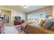Spacious primary bedroom with modern furnishings, a large bed, and plenty of natural light through large windows at 8605 S Zante Ct, Aurora, CO 80016