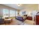 Comfortable primary bedroom with ample natural light, a plush bed, and a cozy seating area by the windows at 8605 S Zante Ct, Aurora, CO 80016