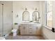 Bathroom featuring a double vanity, modern fixtures, and glass-enclosed shower at 1466 Knox Ct, Denver, CO 80204