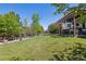 Expansive backyard with lush green lawn, wooden fence and large pergola, perfect for outdoor entertaining at 12189 Windy Trail Ln, Parker, CO 80138