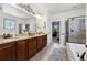 Bathroom featuring granite countertop vanity, soaking tub with stained glass window, and shower at 12189 Windy Trail Ln, Parker, CO 80138