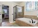 Bathroom featuring a soaking tub and shower with decorative stained glass window and tile surround at 12189 Windy Trail Ln, Parker, CO 80138