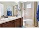 Bathroom features double sinks, wood cabinetry, and a shower-tub combination at 12189 Windy Trail Ln, Parker, CO 80138