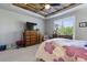 Bright bedroom featuring a reclaimed wood ceiling, ceiling fan, large dresser, and a comfortable bed at 12189 Windy Trail Ln, Parker, CO 80138